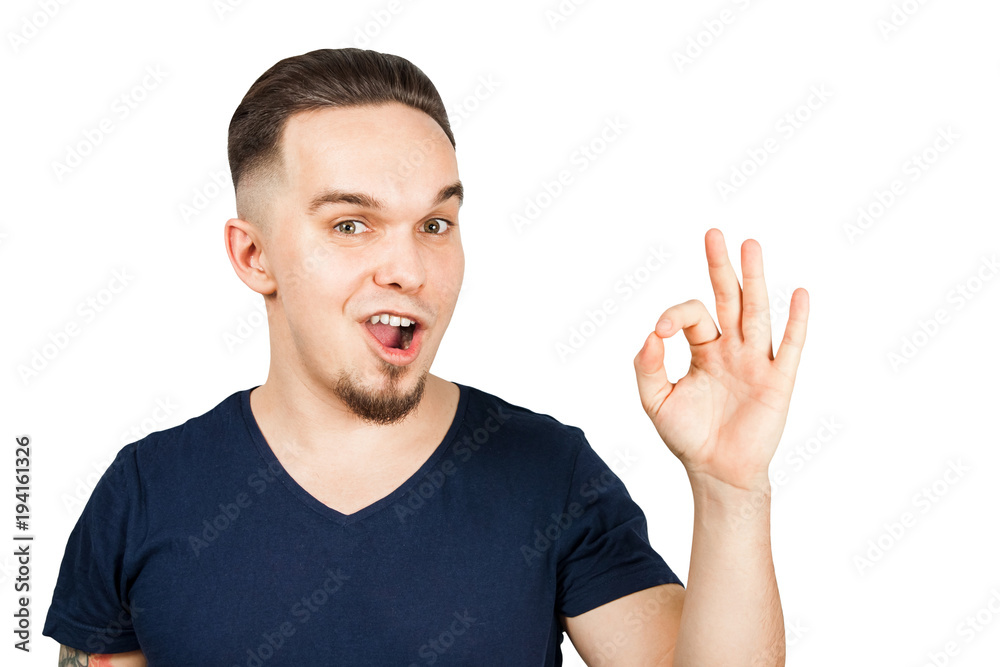 Adult funny guy dressed in T-shirt smiles and shows sign okay. Isolated on white Adult funny guy dressed in T-shirt smiles and shows sign okay. Isolated on white