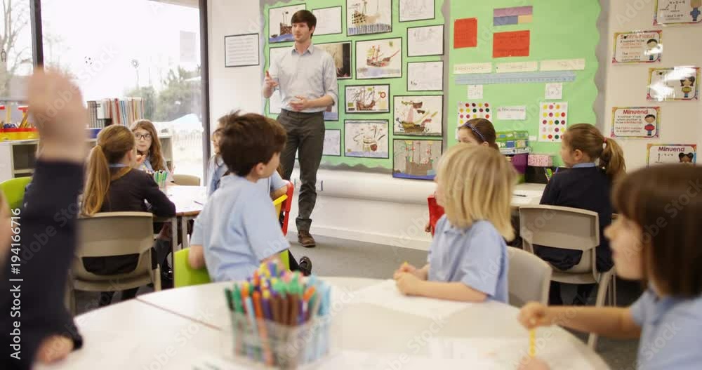 4k, Young teacher educating a group of elementary children. Slow motion.