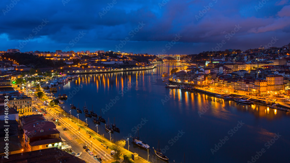 Night view of Douro river and Ribeira from Dom Luis I bridge, Porto, Portugal.