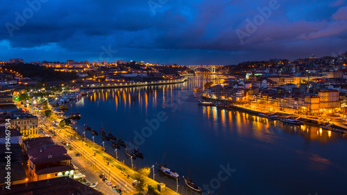 Night view of Douro river and Ribeira from Dom Luis I bridge, Porto, Portugal.