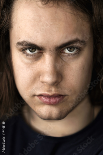 Face and eyes of a young handsome man with expressive eyes closeup