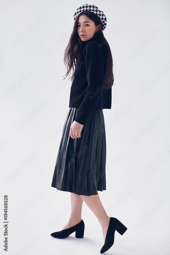 Elegant asian woman in fashionable black skirt and beret Elegant asian woman in fashionable black skirt and beret