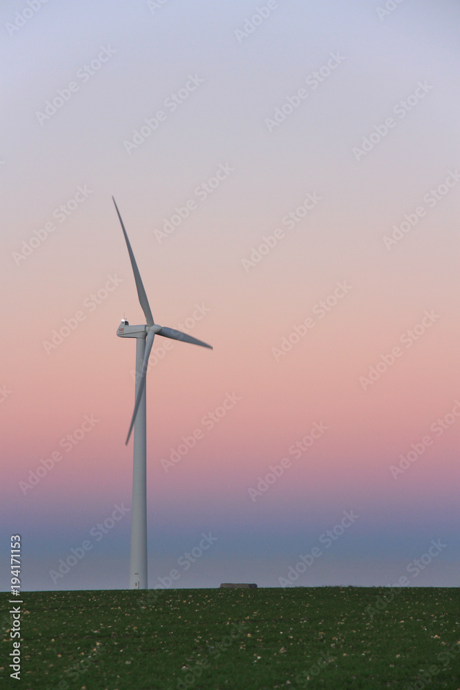 Obraz premium Wind turbine at sunset, France