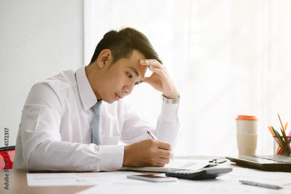 Business man working at office with laptop and documents on his desk Business man working at office with laptop and documents on his desk