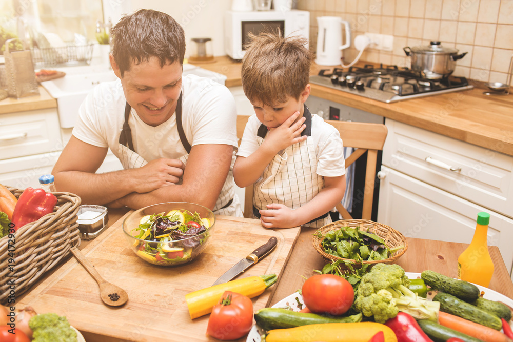 Father is cooking with his son Father is cooking with his son