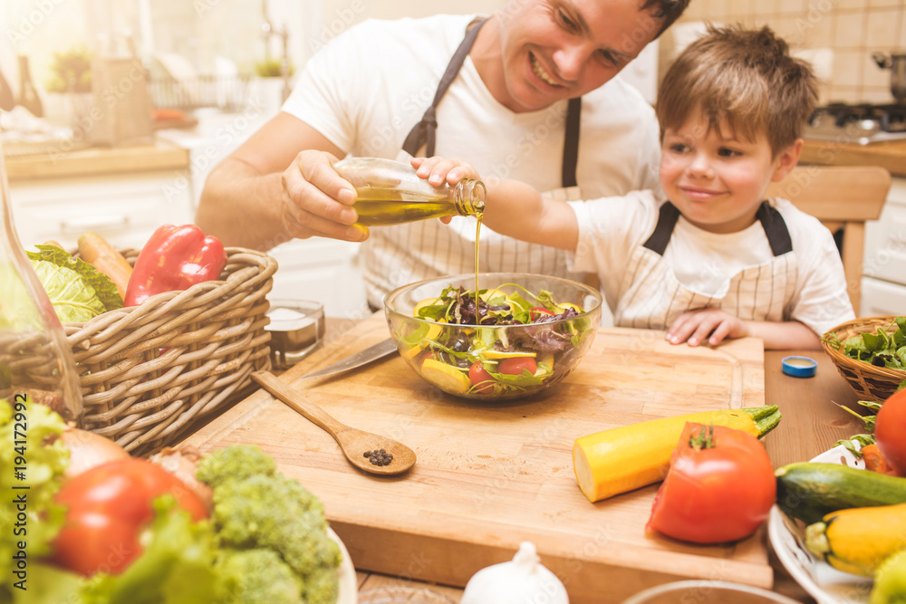 Father is cooking with his son Father is cooking with his son