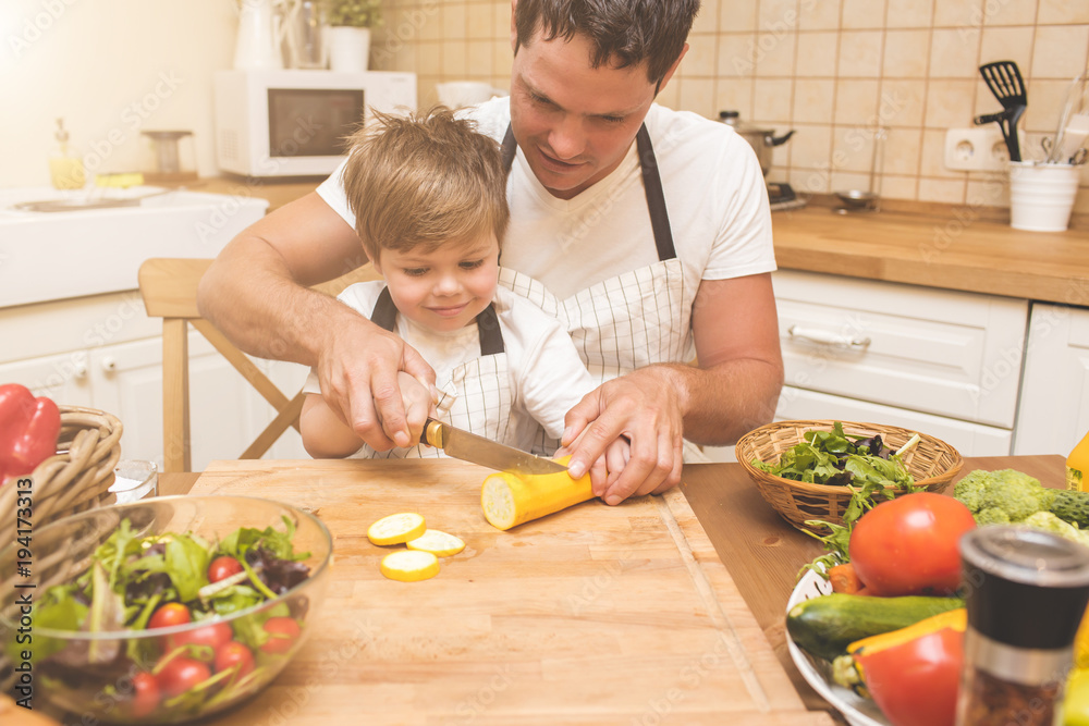Father is cooking with his son Father is cooking with his son