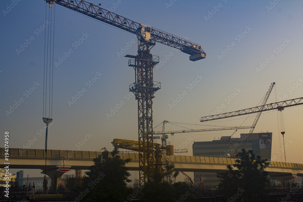 Construction site with cranes at dawn