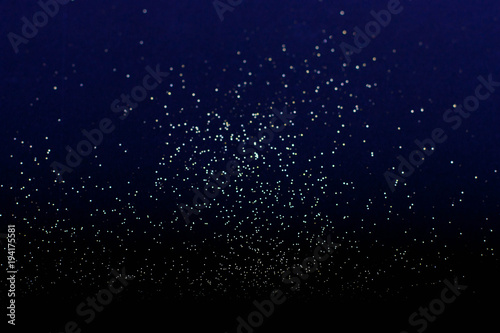 defocused golden defocused glitter on a blue background