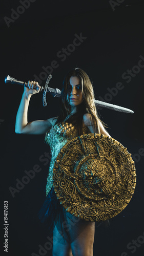 valkyrie warrior, woman with golden armor iron coat and big warrior sword photo