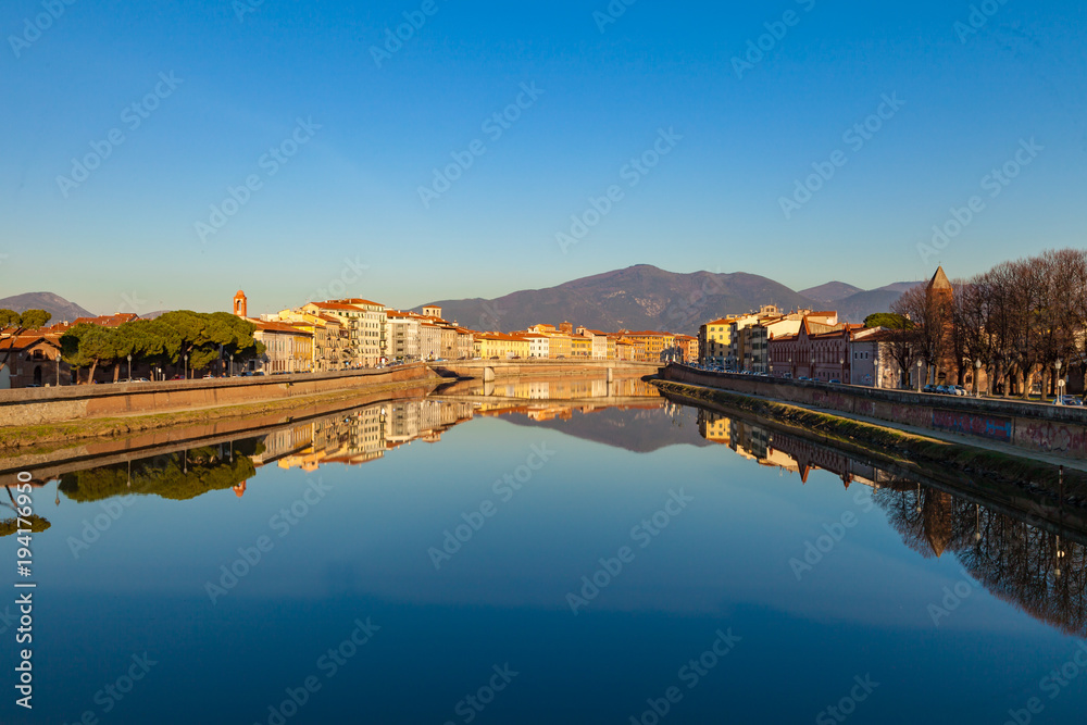 Fototapeta premium Arno river embankment with colorful old houses, view from Ponte della Citadella. Picturesque medieval town of Pisa, Tuscany, Italy.