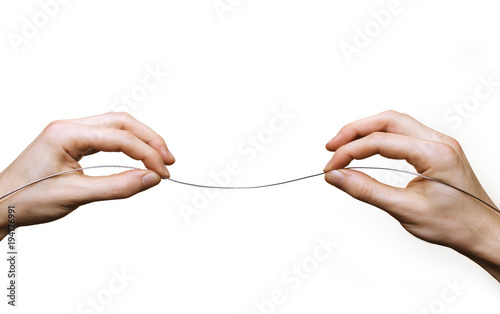 hands suspending tightrope wire
