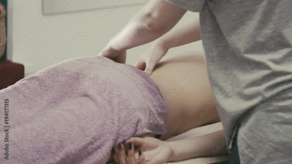 Massage procedure of female back in spa. Masseur massaging back of girl. Healthy lifestyle Massage procedure of female back in spa. Masseur massaging back of girl. Healthy lifestyle