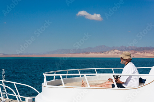 Old man on the boat. © AlesiaKan