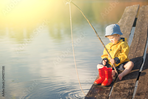 Handsome Young Kid Holding his Fishing Rod photo