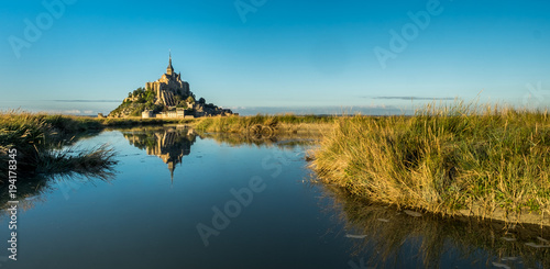 Famous Mont Saint-Michel reflected in evening light photo