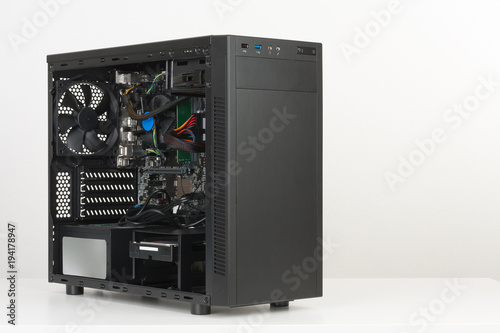 Building of PC, ATX motherboard inserted to black computer midi tower case. photo