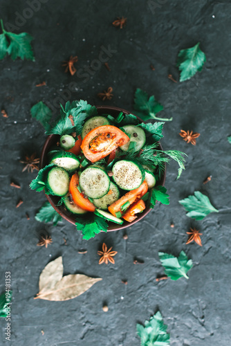 Fresh salad with vegetables on a black matte background. The concept of a healthy diet