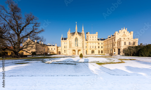 The Lednice castle panorama in snow, winter. Beautiful old historical architecture, blue sky. Czech republic unesco photo
