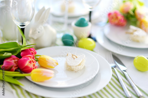 Beautiful table setting with crockery and flowers for Easter celebration © MNStudio