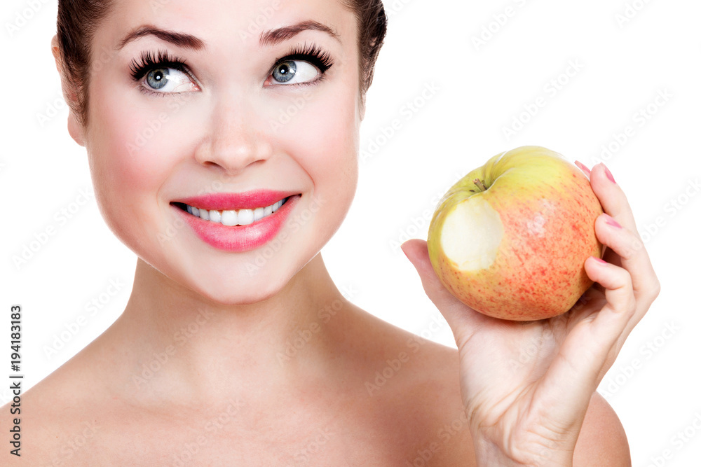 Happily smiling woman with a ripe apple isolated on white background Happily smiling woman with a ripe apple isolated on white background