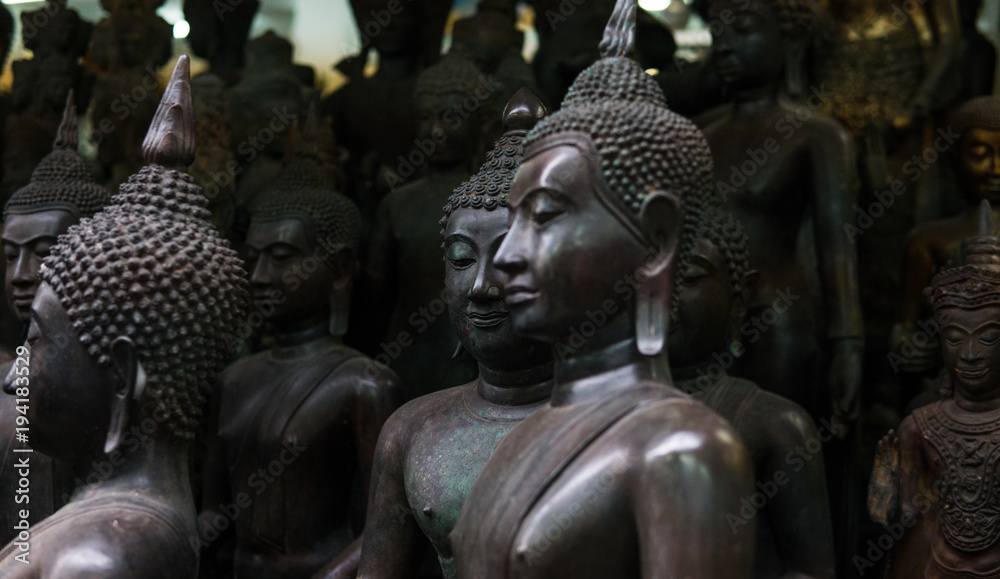 Big Buddha statues in the local Thai market. Antique Buddha statues close-up 