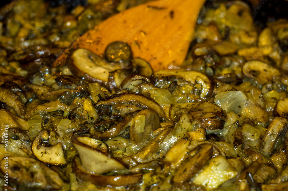 fried with onions and spices Royal mushrooms champignons in a frying pan