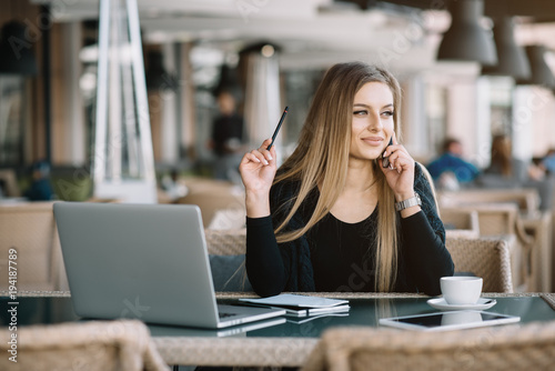 Young beautiful girl preparing for exams with laptop, surfing articles about innovations in web development, programming and design. Business lady working through internet in digital marketing field.