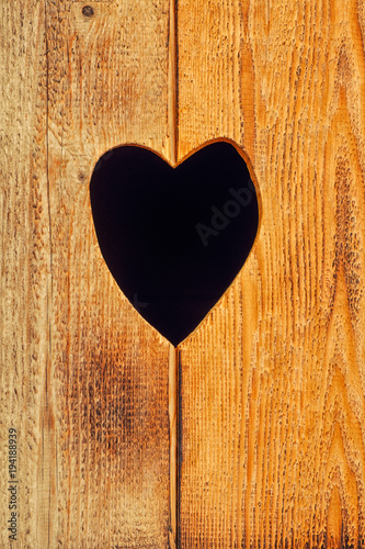 Brown wooden plank background and heart. Wood texture