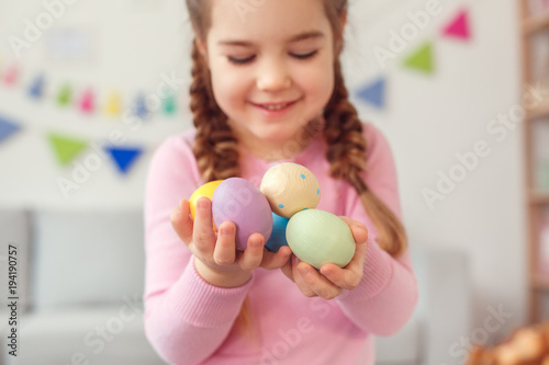Photography Little cute girl easter celebration at home concept standing holding eggs close-