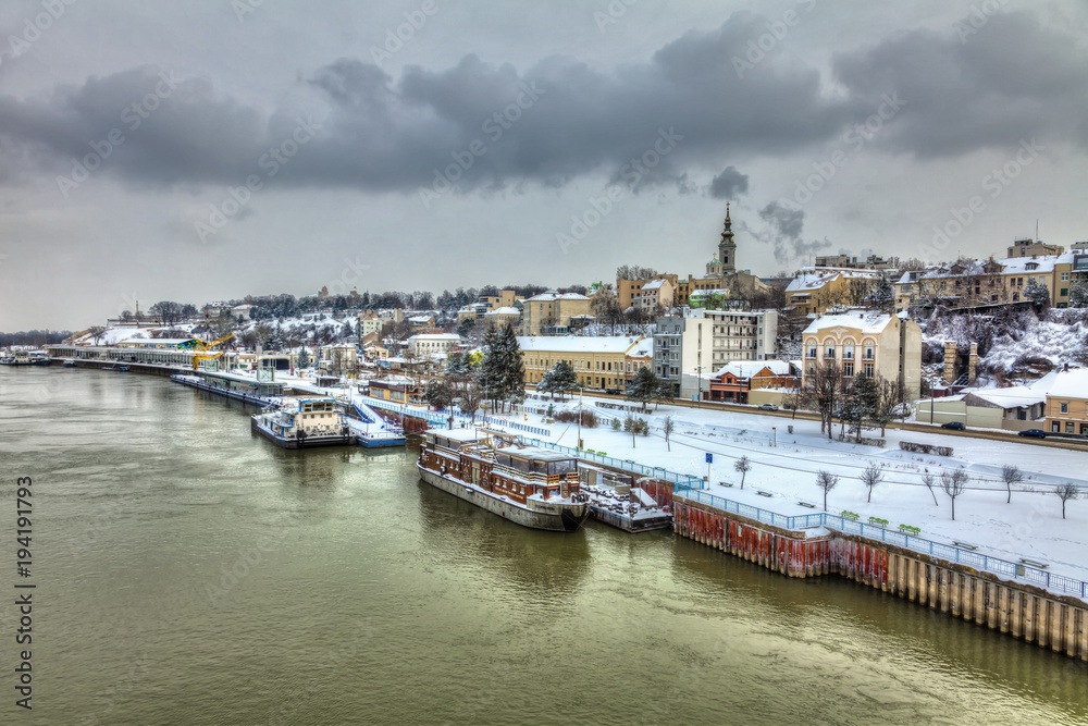 A concrete ship in the Belgrade harbor and a snow covered city. HDR images