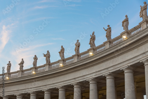 lineup of roman statues at St Peter s square in Rome Italy on gallerie with pillars