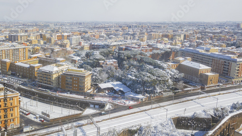 Aerial view of a group of buildings in the Tuscolana district in Rome  Italy. The buildings and streets are unusually covered with snow and ice.The roofs are passable and with antennas and TV dishes.