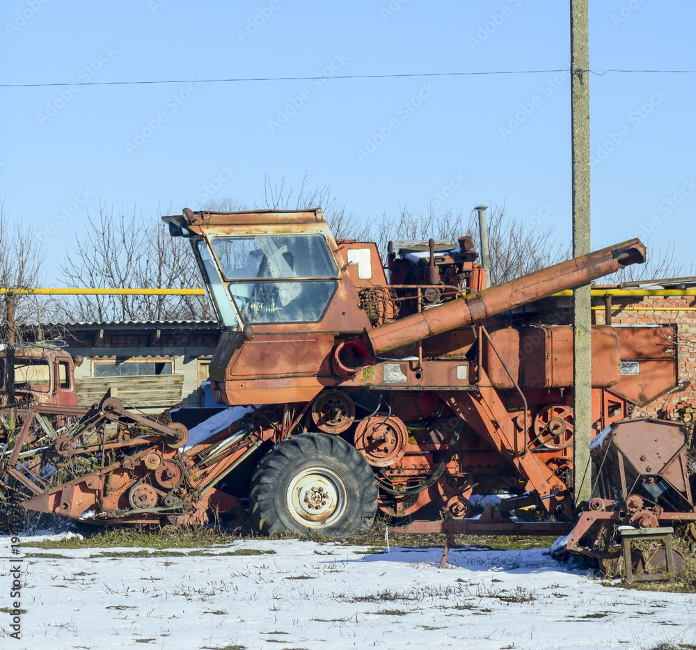Rusty old combine harvester. Garage of agricultural machinery.