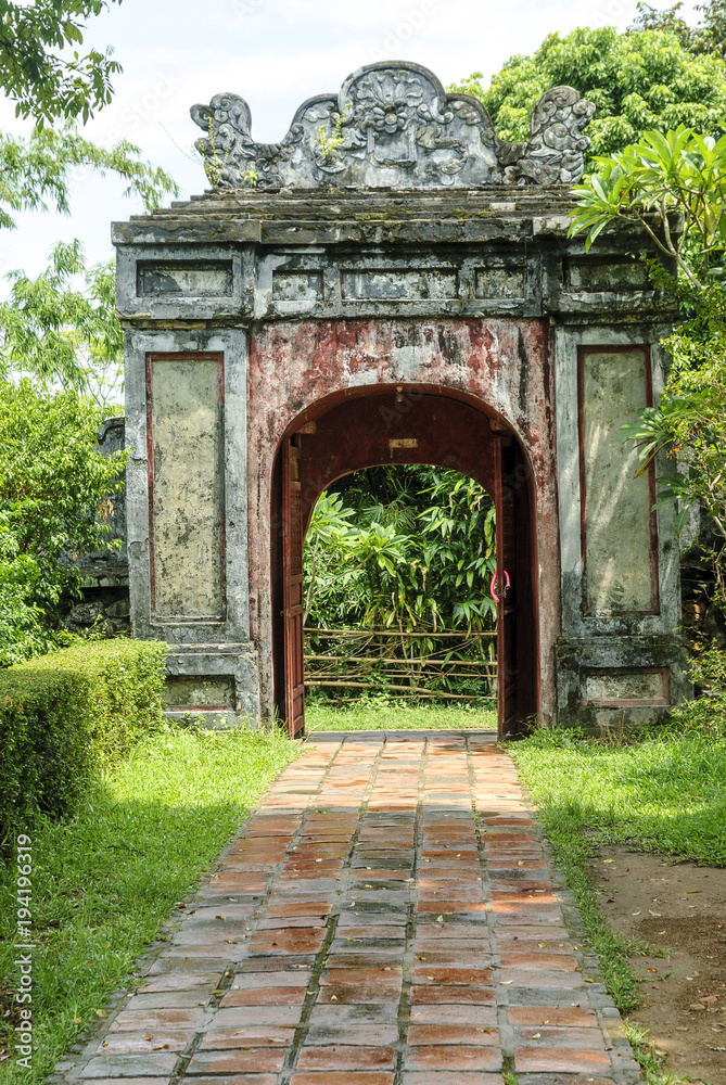 door in the gardens inside the pagoda Thien Mu in the city of Hue, Vietnam.