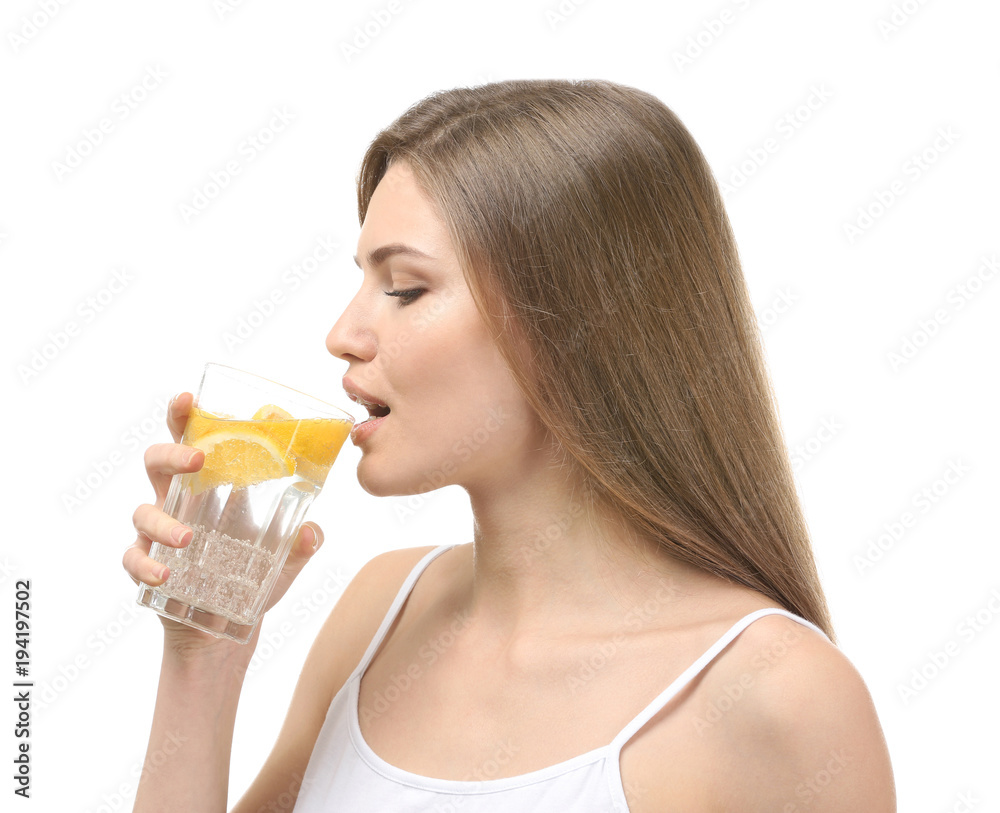 Beautiful young woman drinking fresh lemonade on white background Beautiful young woman drinking fresh lemonade on white background
