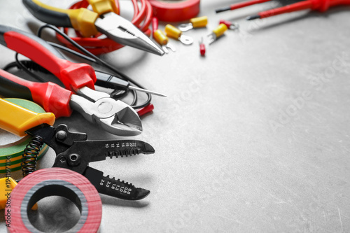 Different electrical tools on grey background