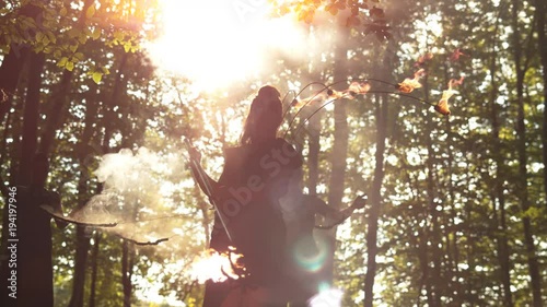 Contre jour of a female artist with fire staffs photo