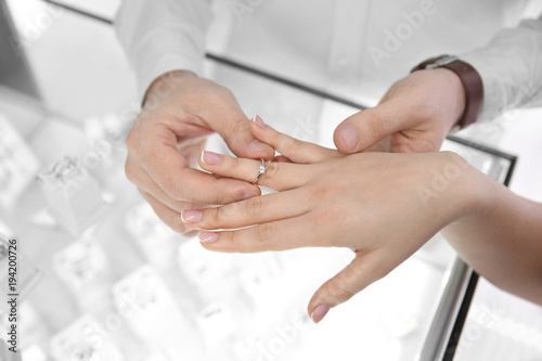 Young couple choosing ring in jewelry store