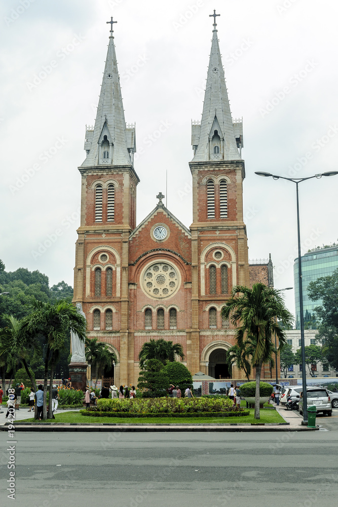 front of the colonial catholic cathedral in city Ho Chi Minh, Vietnam.