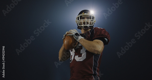 american football player throwing rugby ball