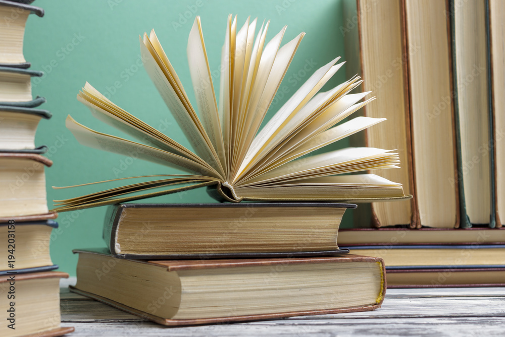 Fototapeta premium Open book, hardback books on wooden table. Back to school. Copy space