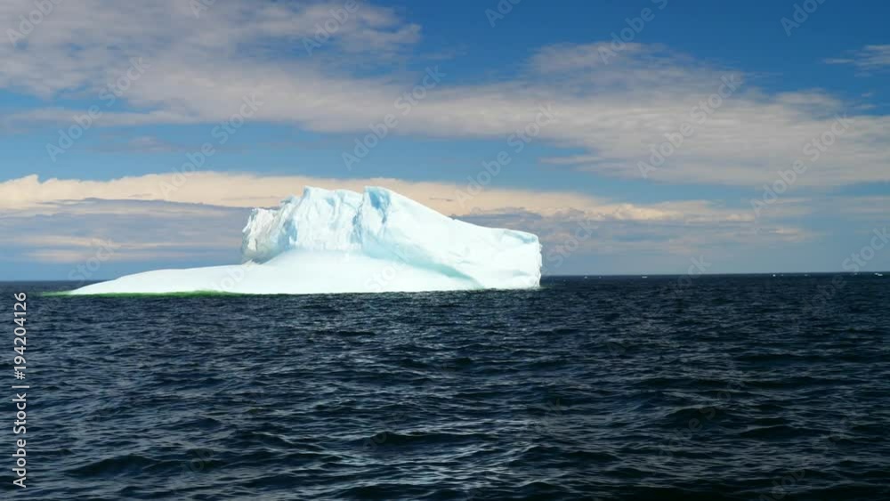 Amazingly big iceberg floating in arctic blue cold water at twillingate Amazingly big iceberg floating in arctic blue cold water at twillingate