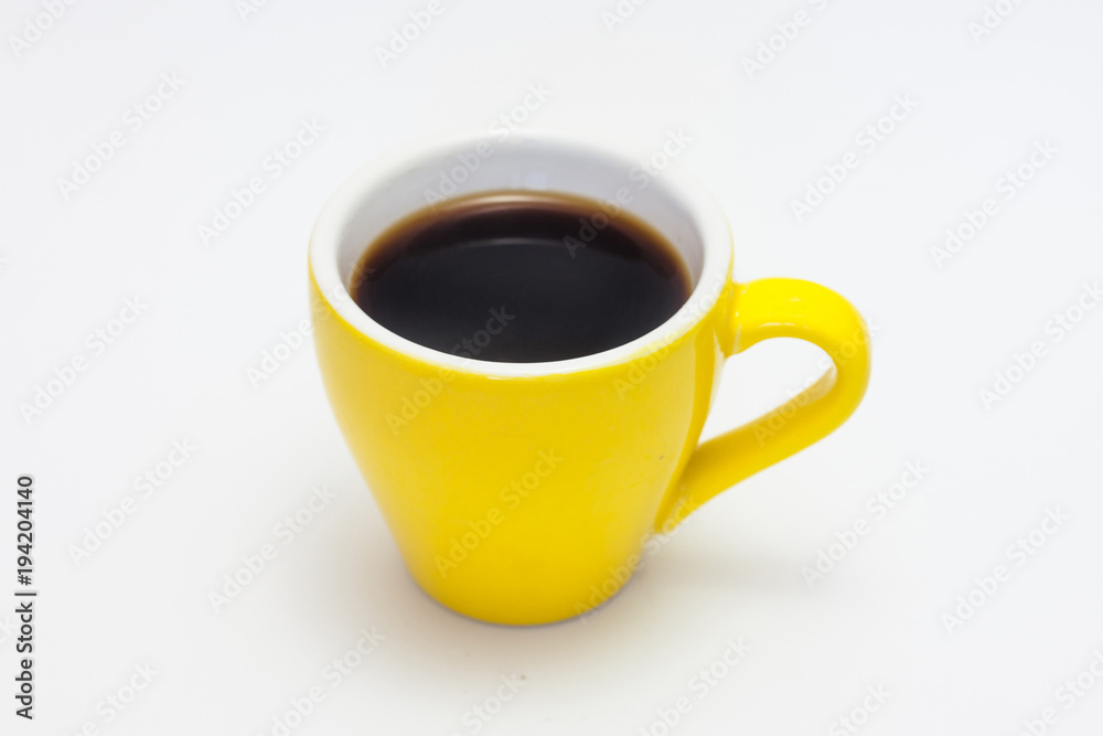 Small, yellow espresso ceramic cup isolated on white. Morning coffee background. Small, yellow espresso ceramic cup isolated on white. Morning coffee background.