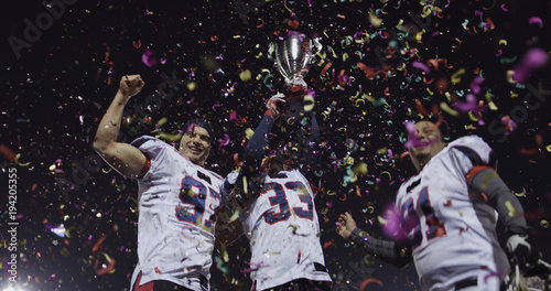 american football team celebrating victory