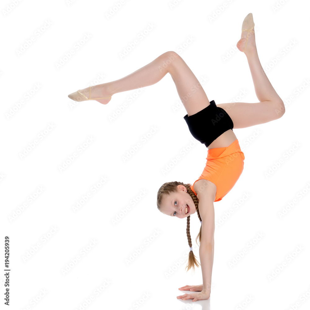 The gymnast performs a handstand with bent legs. The gymnast performs a handstand with bent legs.