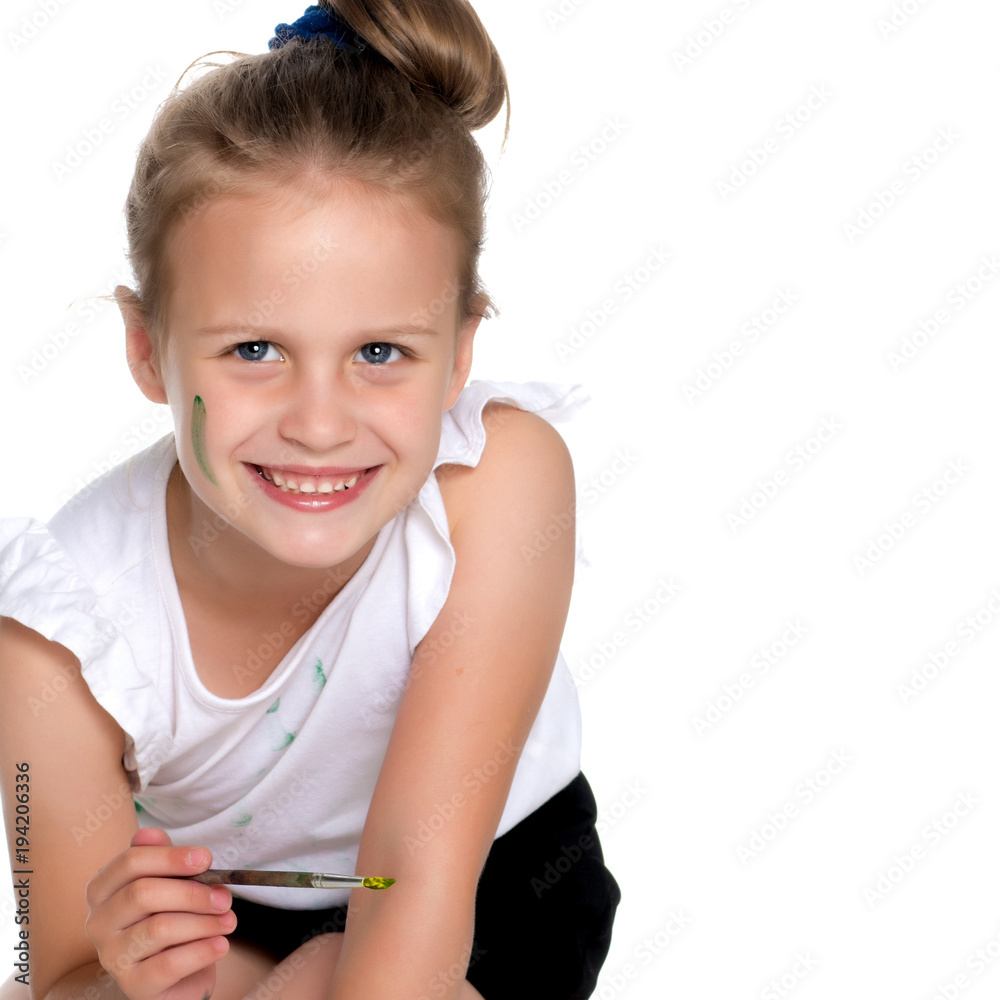 A little girl paints with paint and brush. A little girl paints with paint and brush.