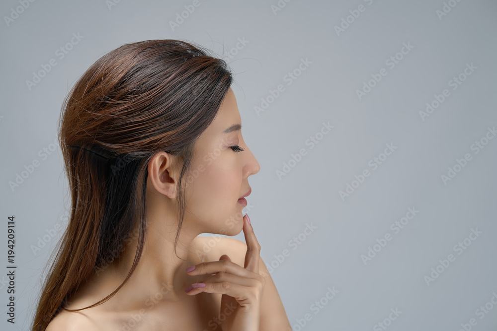 Happy beautiful asian girl with the fresh skin on white background. Expressive facial expressions. Cosmetology and Spa concept. Happy beautiful asian girl with the fresh skin on white background. Expressive facial expressions. Cosmetology and Spa concept.