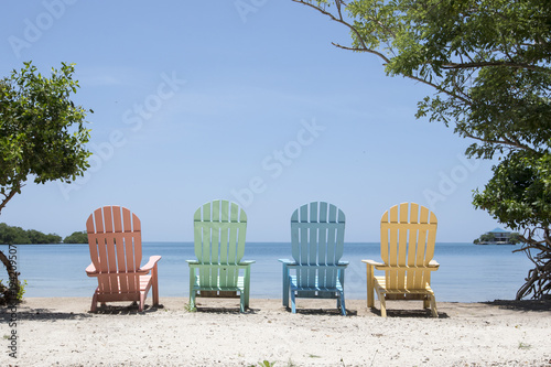 Panorama of colorful lounge chairs at a tropical paradise beach in Cartagena, Colombia photo