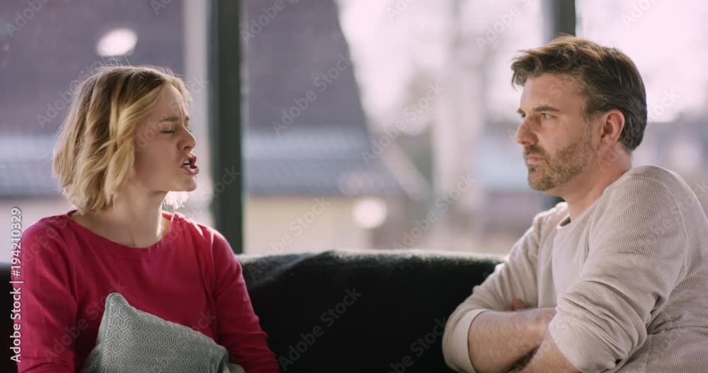 Mid-age Couple arguing at home Mid-age Couple arguing at home